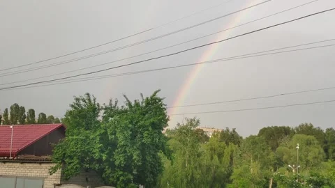 Double bright big rainbow above the buildings. A rainbow over the city Kharkiv Stock Footage 155577257