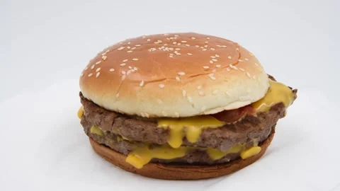 Double cheeseburger against gray background Stock Footage 276704694