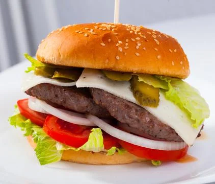Double cheeseburger with beef, tomato, cheese, cucumber and lettuce Stock Photos
