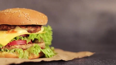 Double cheeseburger on a gray background Stock Footage 255486148