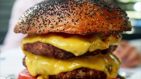 A double cheeseburger with two patties, melted cheddar cheese, and fresh in.. Stock Footage 339792909