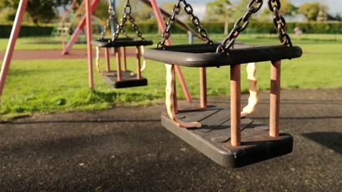 Double children's swing on the playground Stock Footage 154248849