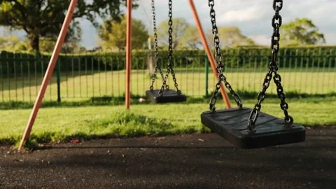 Double children's swing on the playground Stock Footage 154249010