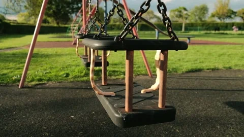 Double children's swing on the playground Stock Footage 154249030