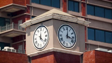 Double clock tower on urban building close up in daylight Stock Footage 332418385