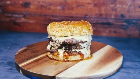 Double Deck Cheese Burger on Rustic Board Stock Footage 323468369