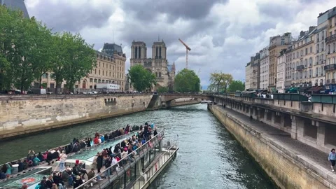 A double-deck ferry carrying tourists sails down the Seine River. Stock Footage 311937019