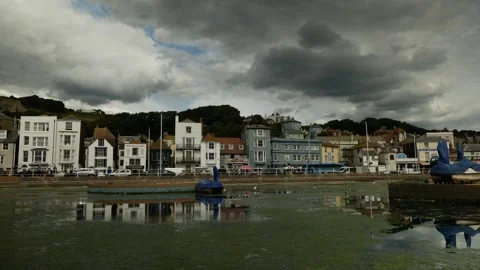 A Double decker British bus reflected in Hastings seaside town 6K Video stock 329901303