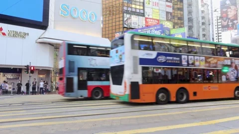 Double Decker Bus and Tram passing by in Causeway Bay Hong Kong Stock Footage 313486502