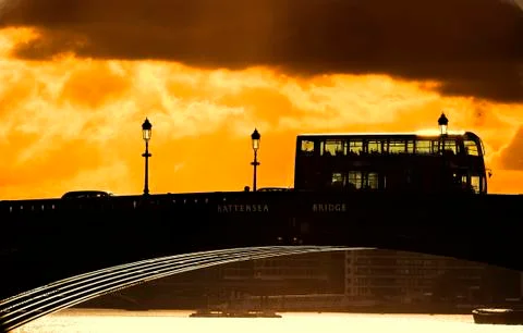 Double decker bus on a backlit bridge Stock Photos