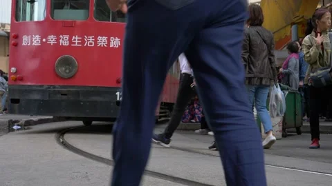 A double-decker bus on a crowded lively street low angle Stock Footage 146587288