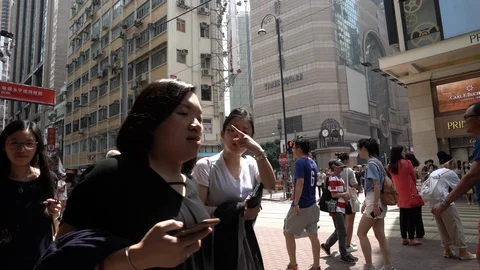A double-decker bus driving past a crossing in downtown Hong Kong Stock Footage 95537615