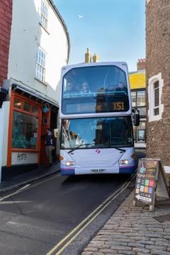 A double decker bus driving through the narrow streets of Lyme Regis Stock Photos