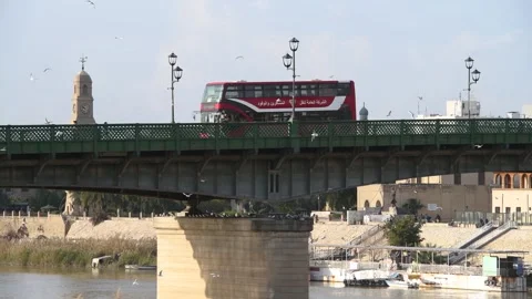 A double-decker bus passes over al-Shuhadaa Bridge in Baghdad, Iraq, 17 Feb 2019 Stock Footage 282164586