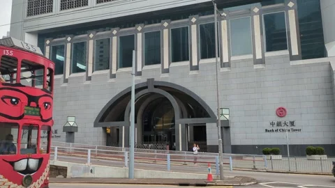Double decker bus tram passing by the bank of China tower Hong Kong Stock Footage 271235461
