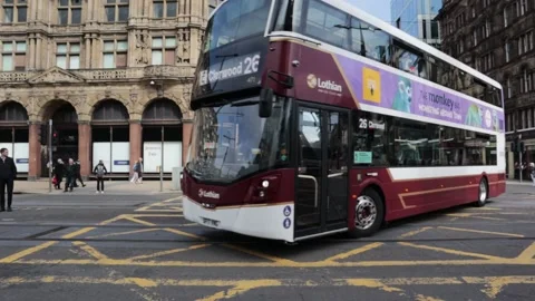 Double Decker Bus travels down city shopping street Stock Footage 170823148
