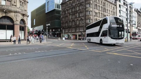 Double Decker Bus travels down city shopping street Stock Footage 170823171