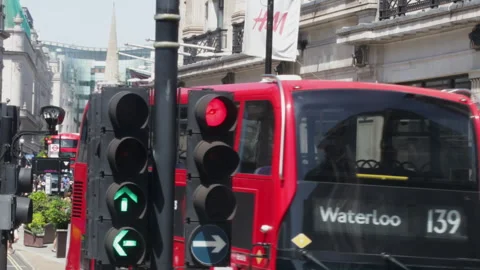 Double-Decker Buses and Pedestrians on Busy London Street with Traffic Lights Stock Footage 340297319