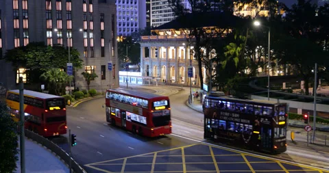 Double decker buses and trams driving at night in Central, Hong Kong Stock Footage 309402328