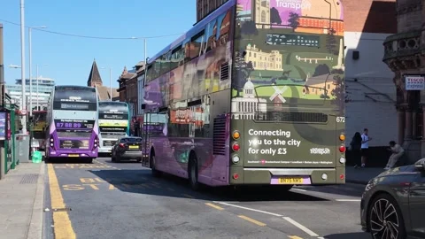 Double-decker buses at a city bus stop on a sunny day Stock Footage 341007162