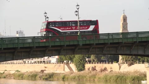 Double-decker buses drive over al-Shuhada Bridge in Baghdad on 12 January 2019 Stock Footage 282165073