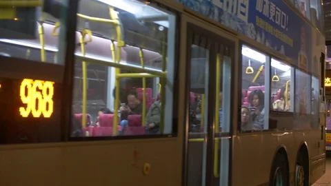 Double Decker Buses Drive past a Stop at Night in Hong Kong 4k Stock Footage 123141828