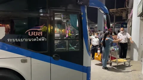 Double decker buses park at platform at Bangkok bus terminal (chatuchak) - Night Stock Footage 189435762