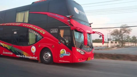 A double-decker tour bus drives along the highway in the early evening Stock Footage 270311286
