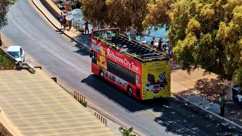 Double-decker tourist bus operating a sightseeing tour Crete Rethymno Greece Stock Footage 332392006