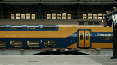 Double decker train arriving at Amsterdam Centraal station Stock Footage 334785676