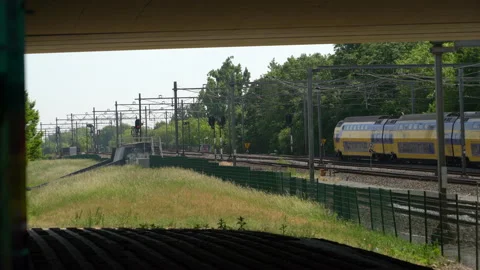 Double decker Train leaving the Amsterdam Sloterdijk train station Stock Footage 131336632