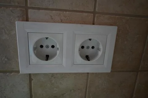 Double electrical outlet on tiled wall Stock Photos