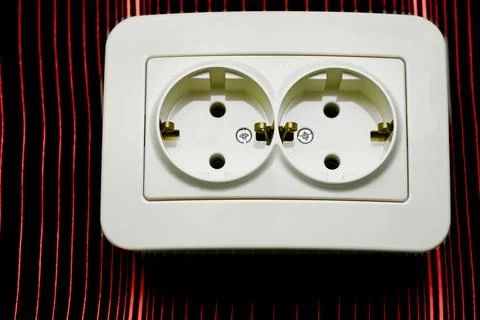 Double electrical plug socket for connecting devices on shiny red Stock Photos