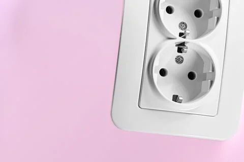 Double electrical socket for connecting devices on pink Stock Photos