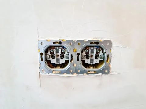 Double electrical socket installed on a white wall. Stock Photos