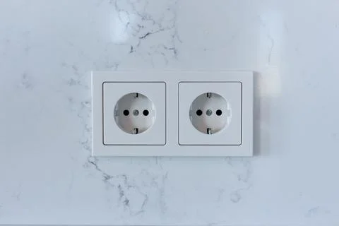 Double electrical socket on a white wall in the room Stock Photos