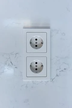 Double electrical socket on a white wall in the room Stock Photos