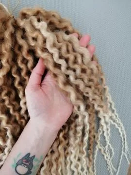 Double ended synthetic corrugated dreadlocks blonde and rose Stock Photos
