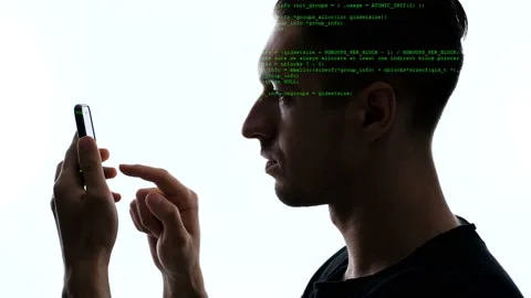 Double exposition of man programmer using smartphone with green code on him Video stock 109138000