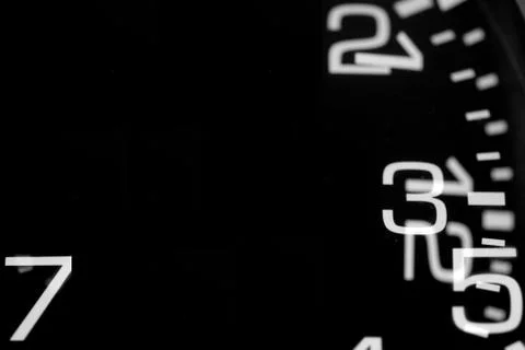 Double exposure of a black clock showing numbers Stock Photos