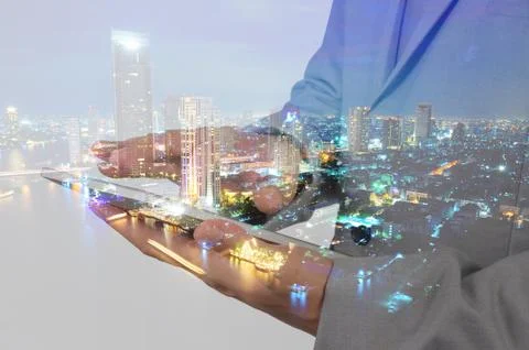 Double Exposure of Business Man using Mobile Tablet and City Stock Photos