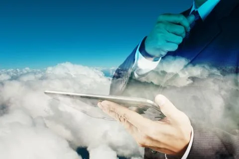 Double exposure of businessman hand using digital tablet with cloud as concep Illustrazione stock