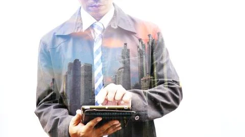 Double exposure of businessman using tablet with city Stock Photos