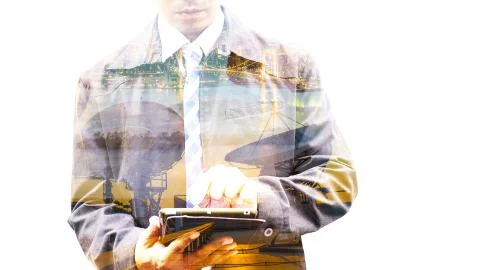 Double exposure of businessman using tablet with city Stock Photos