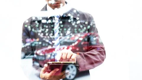 Double exposure of businessman using tablet with car in showroom Stock Photos
