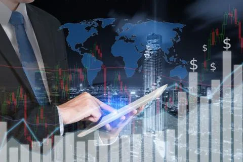 Double exposure of businessman using the tablet with city and financial graph Stock Photos