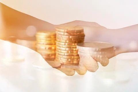 Double exposure of coins stack with handshake Stock Photos