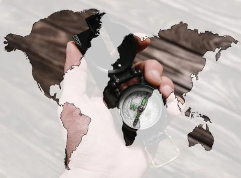 Double exposure of compass in a hand  with map of world. Stock Photos