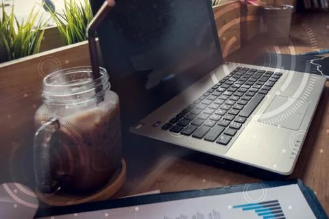 Double exposure of computer on the table inside coffee shop. Stock Photos