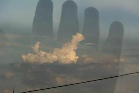 Double exposure of hand and clouds. Double exposure with a digital camera. Foto stock